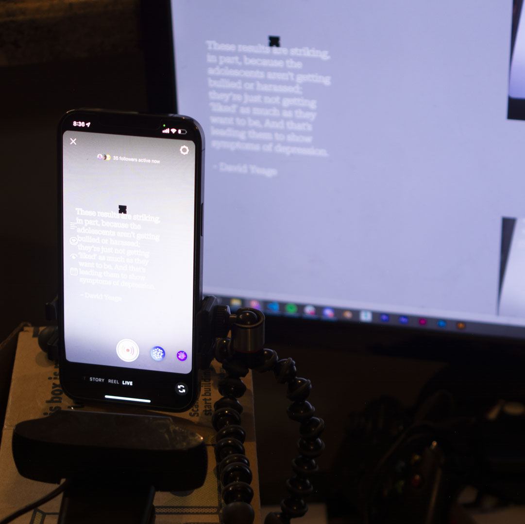 behind the scenes photo of iphone pointed at monitor